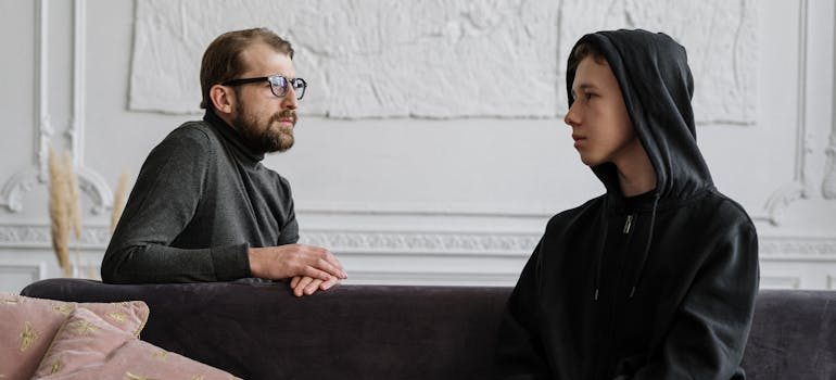 A man and a teenager talking about self-harm and substance abuse often go together