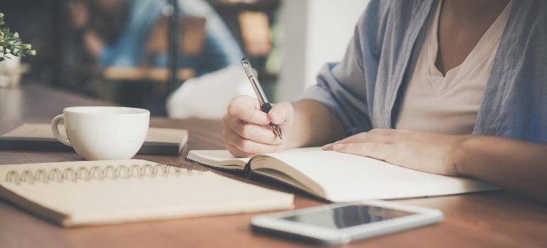 Someone journaling. about how to break free from toxic relationships during early recovery.