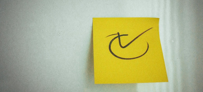 Yellow sticky note with a check mark symbol