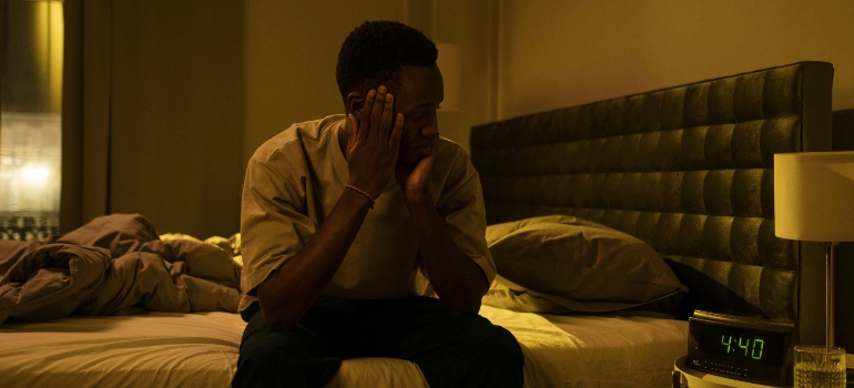 A person sitting awake in bed at night