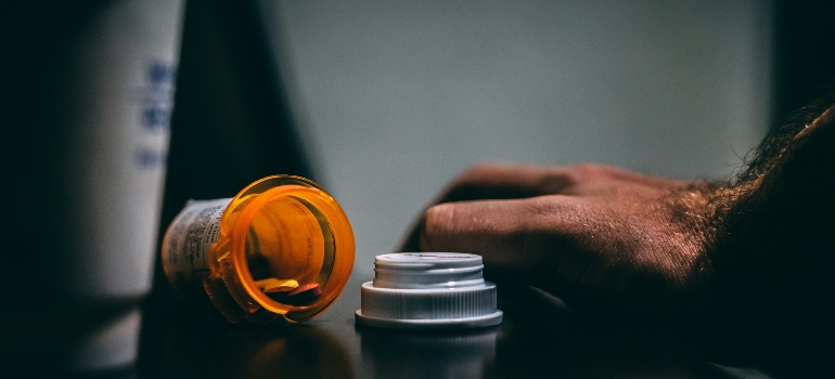 A person holding a pill bottle.